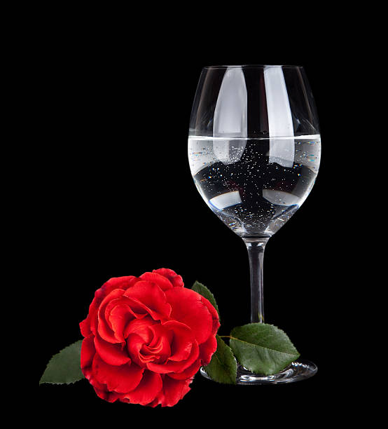 istock glass with water and  flower isolated on black background 177546377