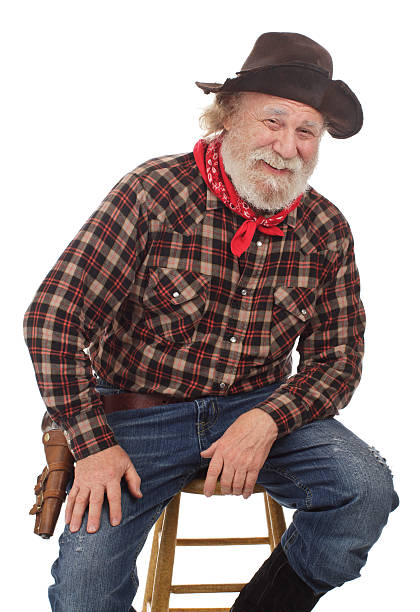 istock Cheerful old cowboy sits on a stool 177546378