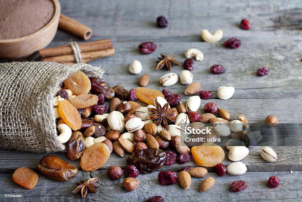 Nuts and dried fruits mixed Nuts and dried fruits mixed on wooden boards Dry Stock Photo