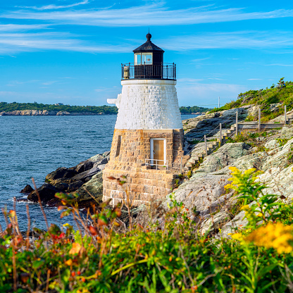 Castle Hill Lighthouse in Newport, Rhode Island on a sunny day.