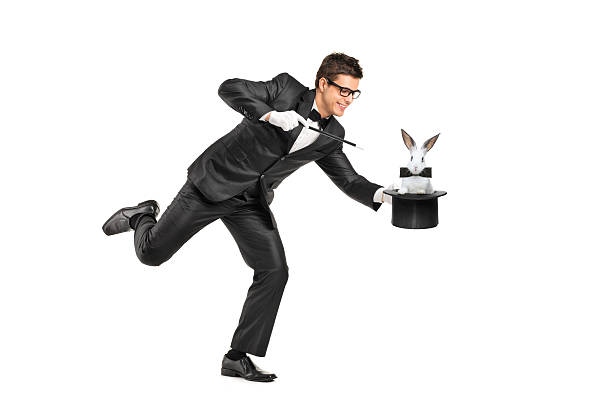 Young magician holding a top hand with rabbit in it