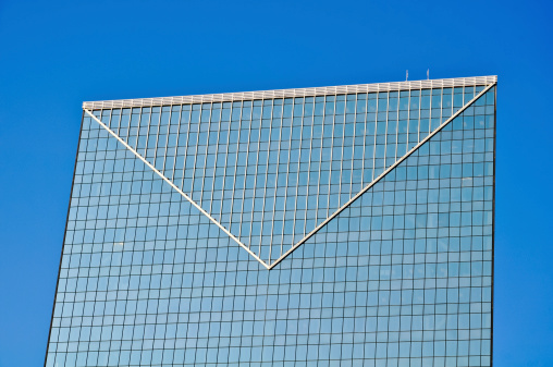 Closeup glass wall of office building with reflection of office buildings, background with copy space, full frame horizontal composition