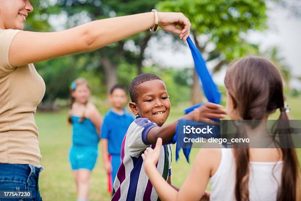 Children And Teacher Playing Games In City Park Stock Photo - Download Image Now - Summer Camp, Child, Flag