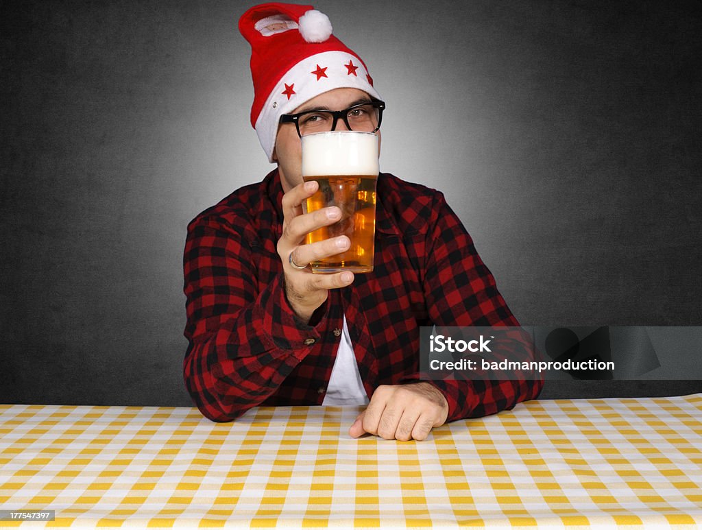 Beer present Bad santa giving the beer for present. Selective focus on the glass of beer. Beer - Alcohol Stock Photo