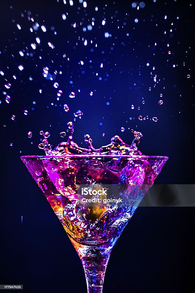 Splashing cocktail rich in colors  colourful coctail on the black background Martini Stock Photo