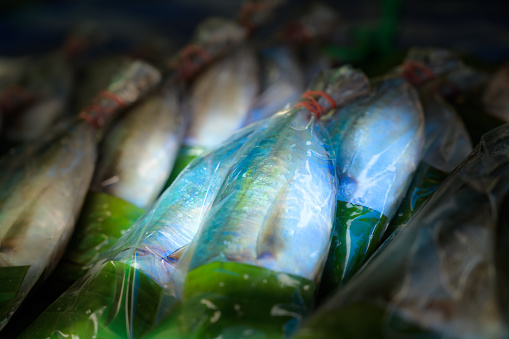 Mackerel fish in plastic bag on stall, Thailand.