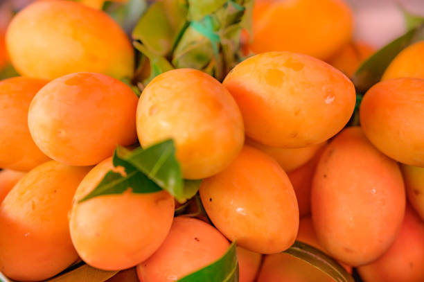 Fresh Plum mango fruit on the stand at the market Fresh Plum mango fruit on the stand at the market, Thailand. griff stock pictures, royalty-free photos & images
