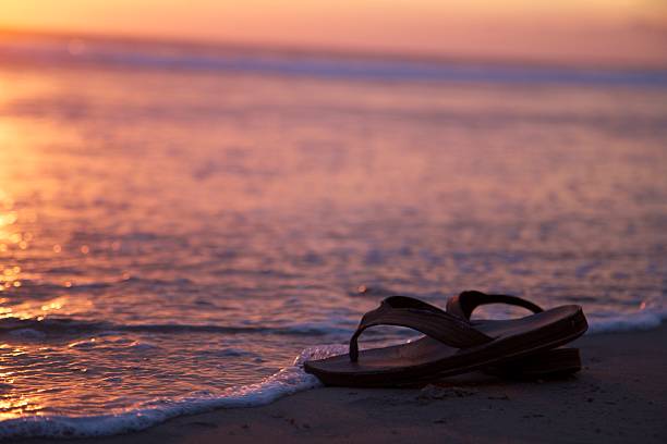 istock Sandals Near Water on a Beach Sunset 177547675