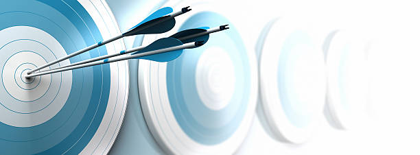 hitting objectives, business strategy many blue targets and three arrows reaching the center of the first one, image fading from blue to white with blur effect, horizontal format dedicated for a banner. Strategic marketing or business competitive advantage concept. bow and arrow photos stock pictures, royalty-free photos & images