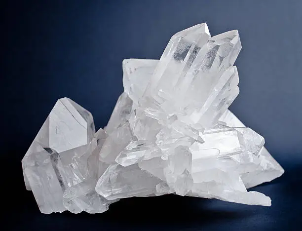 Large crystals of white quartz on dark blue background