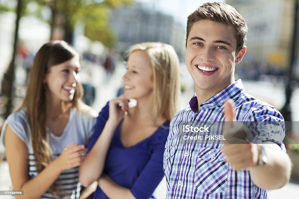 Young man showing thumbs up Adult Stock Photo