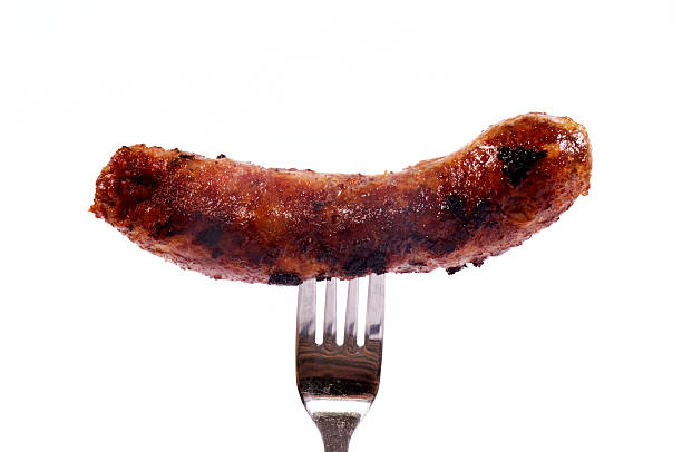 salsiccia sulla forcella - sausage grilled isolated single object foto e immagini stock