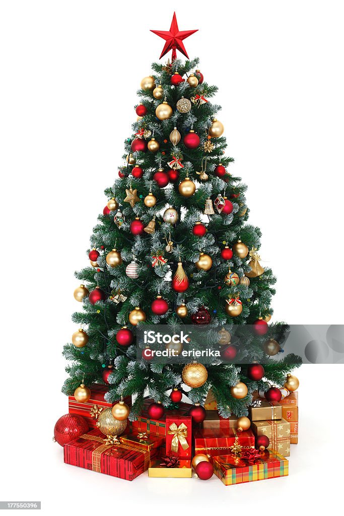 Green decorated Christmas tree and presents "Artificial green Christmas tree, decorated with electric lights, red and golden ornaments, lots of presents under the tree" Artificial Stock Photo