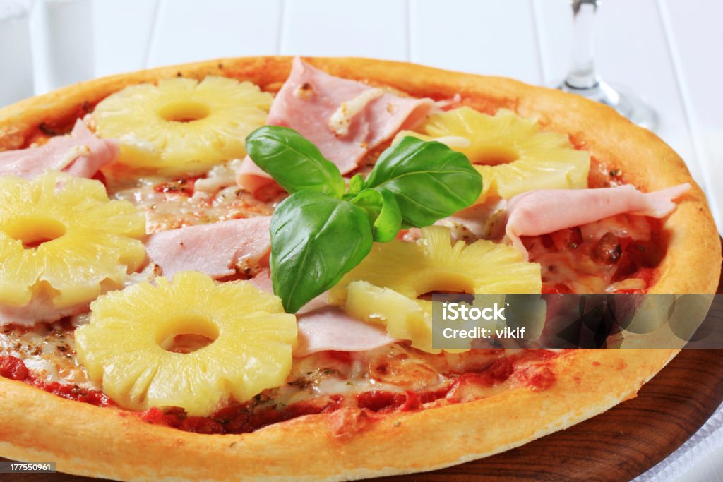 Pizza Hawaii Pizza with pieces of ham and pineapple Baked Stock Photo