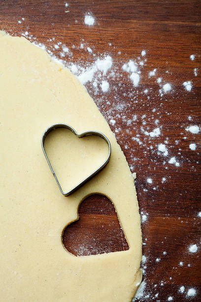 istock Cookie dough on wooden table with heart shaped cookie cutter 177551558