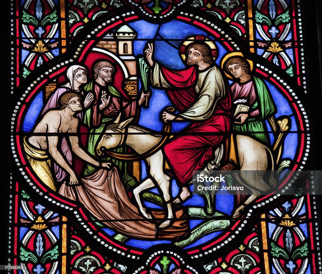 Palm Sunday Jesus enters Jerusalem on a donkey on Palm Sunday. This window is located in the cathedral of Brussels. Palm Sunday Stock Photo