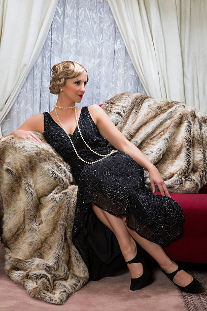 Twenties lady Color photo with reenactment of a vintage scene with a lady in the roaring twenties style chaise longue woman stock pictures, royalty-free photos & images