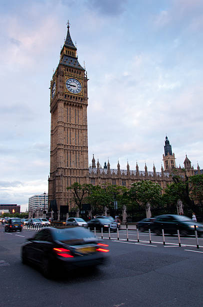 Big Ben and street traffic with blurred cars.