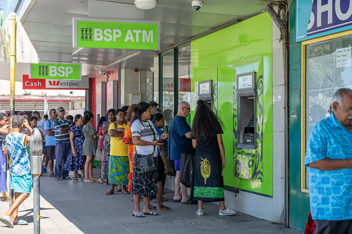 Sigatoka Fiji -September 8 2023; Long queue or line of people in street queuing outside ATM to get cash out.