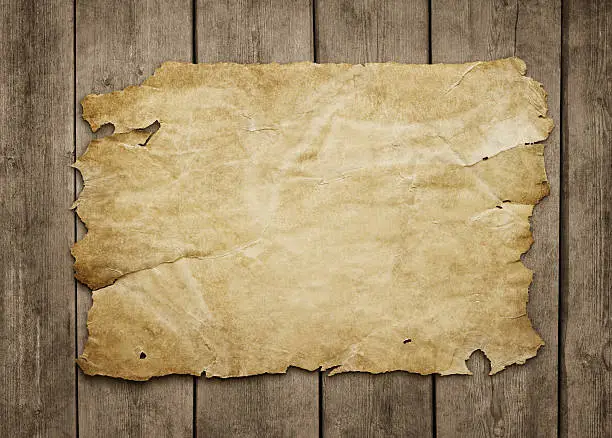 Photo of Old paper sheet at wooden background