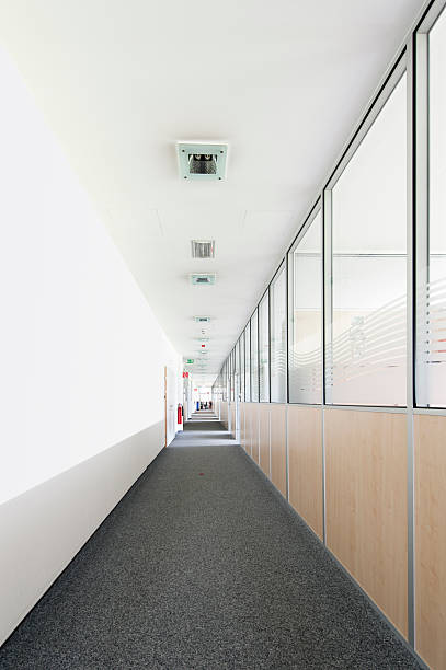 istock very long office corridor with fabric carpet and glass walls 177555085