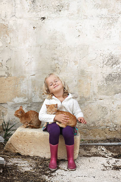 istock Girl with cats 177556235
