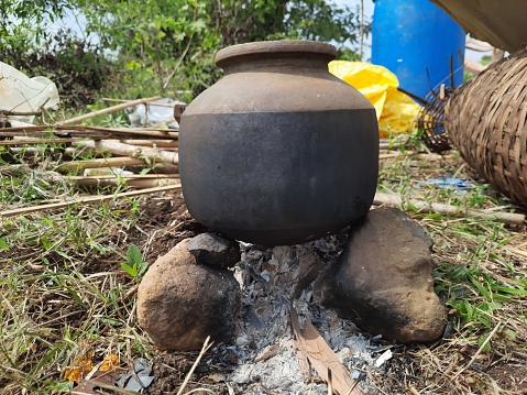 closeup of temporary stone stove with earthen pot above.scene from outdoor events in rural india