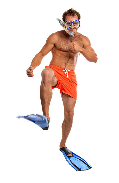 Caucasian swimmer wearing mask, snorkel and flippers walking
