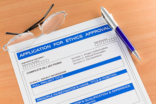 Application for Ethics Approval Form on Table Application for Ethics Approval Form on Table with Pen and Spectacles research ethics stock pictures, royalty-free photos & images