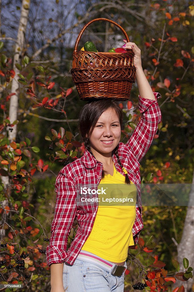 Girl with basket of vegetables Girl holding a basket of vegetables in garden Active Lifestyle Stock Photo