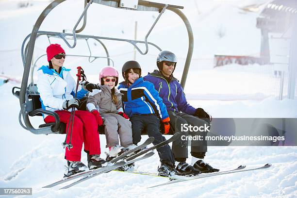 Family Getting Off Chair Lift On Ski Holiday In Mountains Stock Photo - Download Image Now