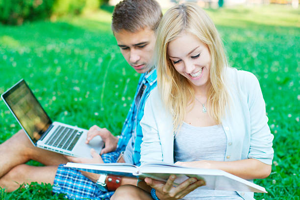 istock Smiling young couple studying outdoors 177560347