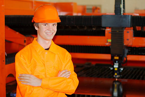 Smiling young worker near a laser