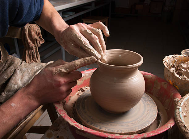 istock hands of a potter, creating an earthen jar 177560539