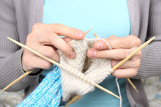 istock woman knitting blue socks closeup 177561628