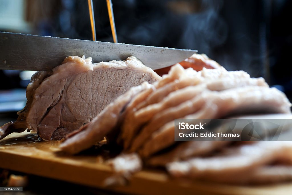 Sunday Roast Pork being carved up ready for a Sunday lunch. Carving Set Stock Photo