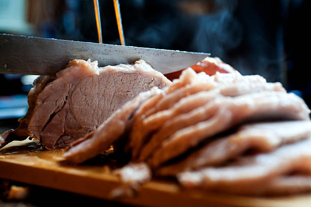 Sunday Roast Pork being carved up ready for a Sunday lunch. carving set stock pictures, royalty-free photos & images