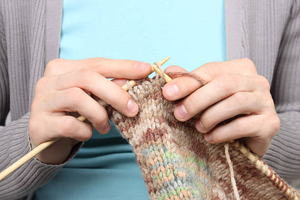 istock woman knitting brown threads closeup 177561691