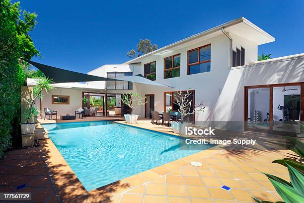 Rectangular Swimming Pool In Back Of A Large White House Stock Photo - Download Image Now