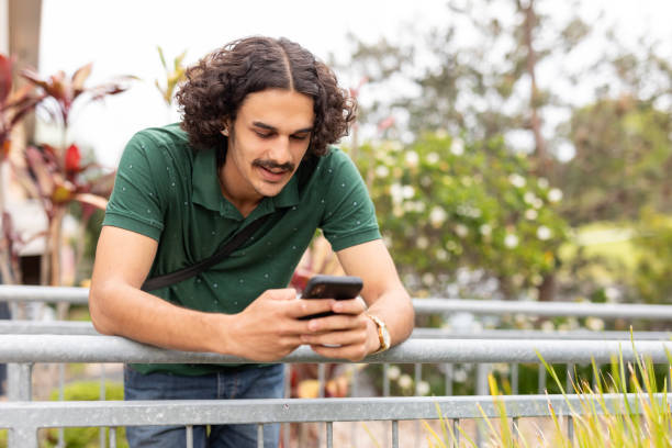 istock Young multiracial man using a mobile phone outdoors 1775653214