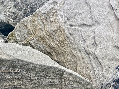 Horizontal close up of weather worn sandstone rocks along promenade at beach side showing beauty in nature in elements at Brunswick Heads Australia