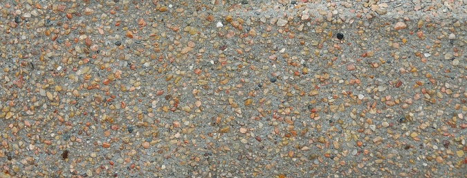 Photograph of pebbles embedded in concrete. Great for texture.