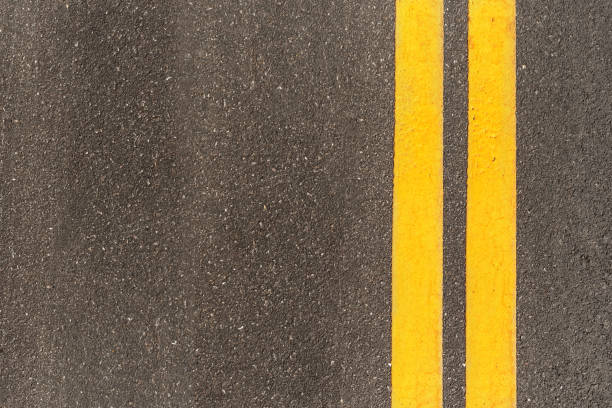 istock Black asphalt road texture with marking background. Double yellow line on asphalt road. 1775684554