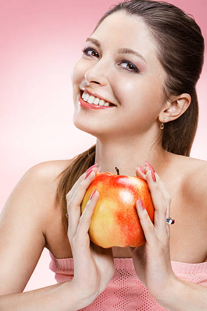 istock Young beautiful girl with an apple 177569257