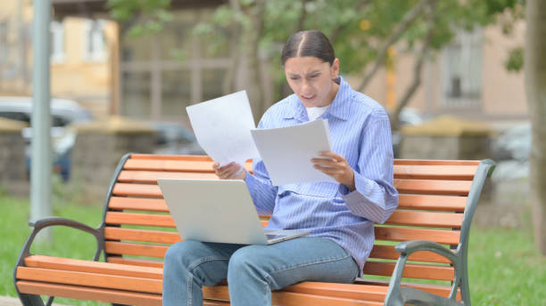 istock Hispanic Woman Feeling Upset while Reading Contract and Using Laptop Outdoor 1775693386