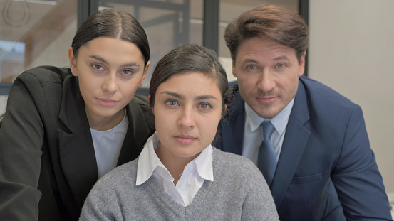 Portrait of Indian Businesswoman with Teammates Looking at Camera