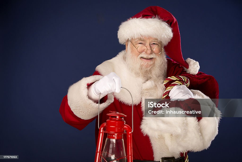 Pictures of Vintage Real Santa Claus carrying gift sack Pictures of Vintage Real Santa Claus carrying gift sack. This pictures a horizontal composition and isolated on Blue. Adult Stock Photo