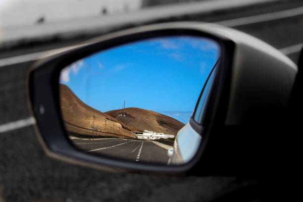 istock rear view mirror of motorcyclist's car reflecting mountain view 1775721697