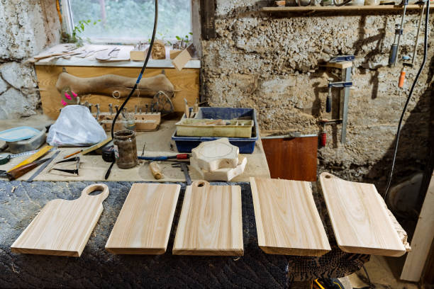 istock carpentry workshop with tools for woodworking, workbench for working with boards, dust mask and leather gloves, a set of wooden blanks for cutting boards, shop 1775736532