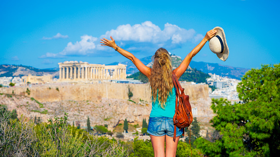 Happy woman tourist enjoying panoramic view of Acropolis- Athens in Greece